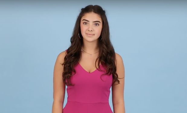 Screenshot of framing criteria shows a girl with long hair in the middle of a black blue background. Framing is about two inches above her head and stops just below the waist.